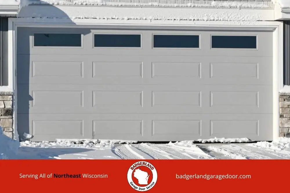Snow covered Wisconsin garage door demonstrating winter conditions Bestland Garage Door provides service to protect with weatherproofing.