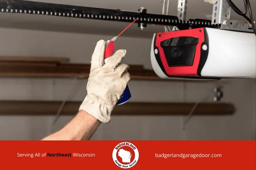 Homeowner clearing snow from garage door to improve winter safety and protect equipment. Bestland Garage Door Service.