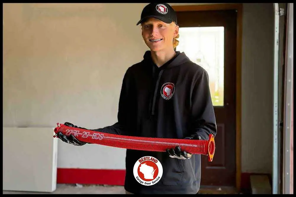 Signs Your Garage Door Spring Is About to Fail-3.jpg Garage door technician checking a failing garage door spring