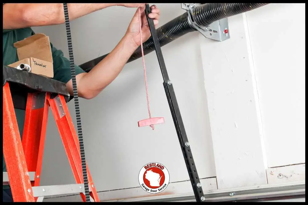 Technician installs garage door opener belt and emergency release