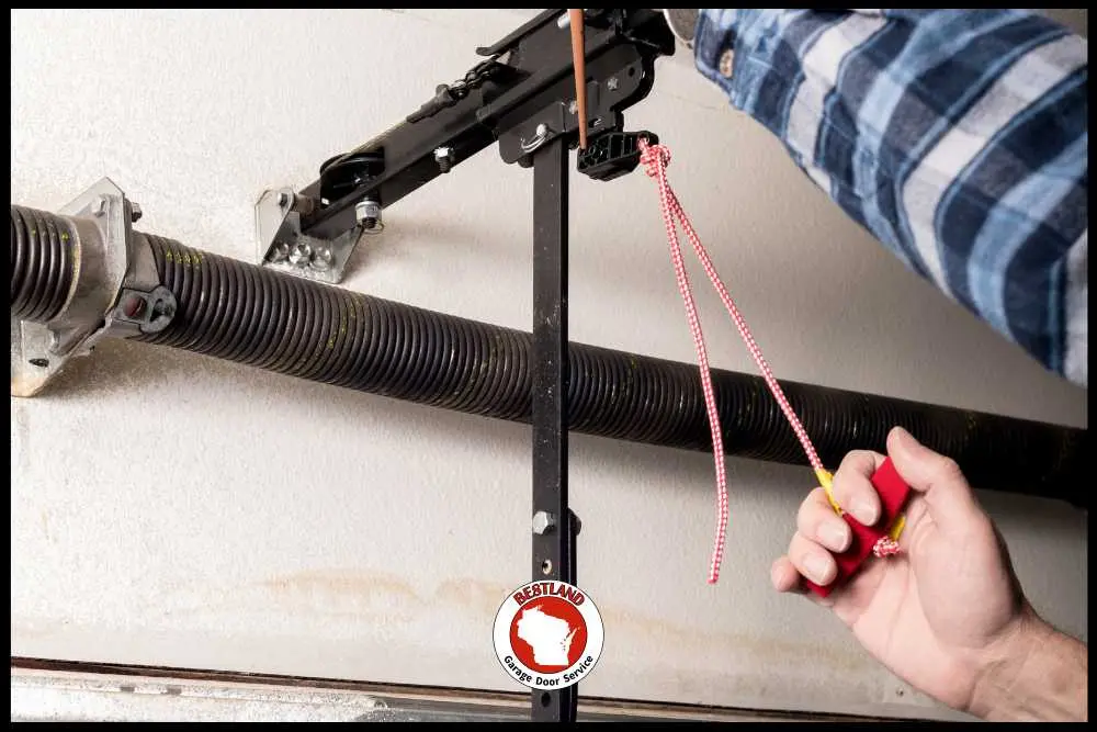 Person pulls garage door emergency release cord