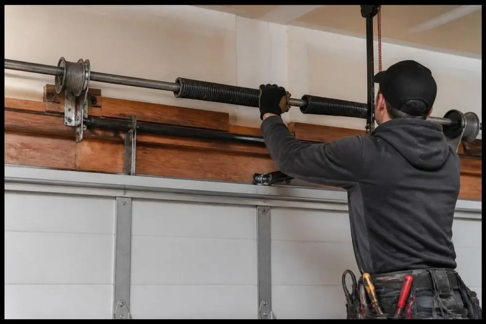 Garage door spring and cable components associated with warning sounds